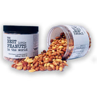 Jars of The BEST little PEANUTS in the world by GORP world. The jar on the left with a black lid. The jar on the right is spilled over with the Spanish Peanuts pouring out onto a white table. 300g jars